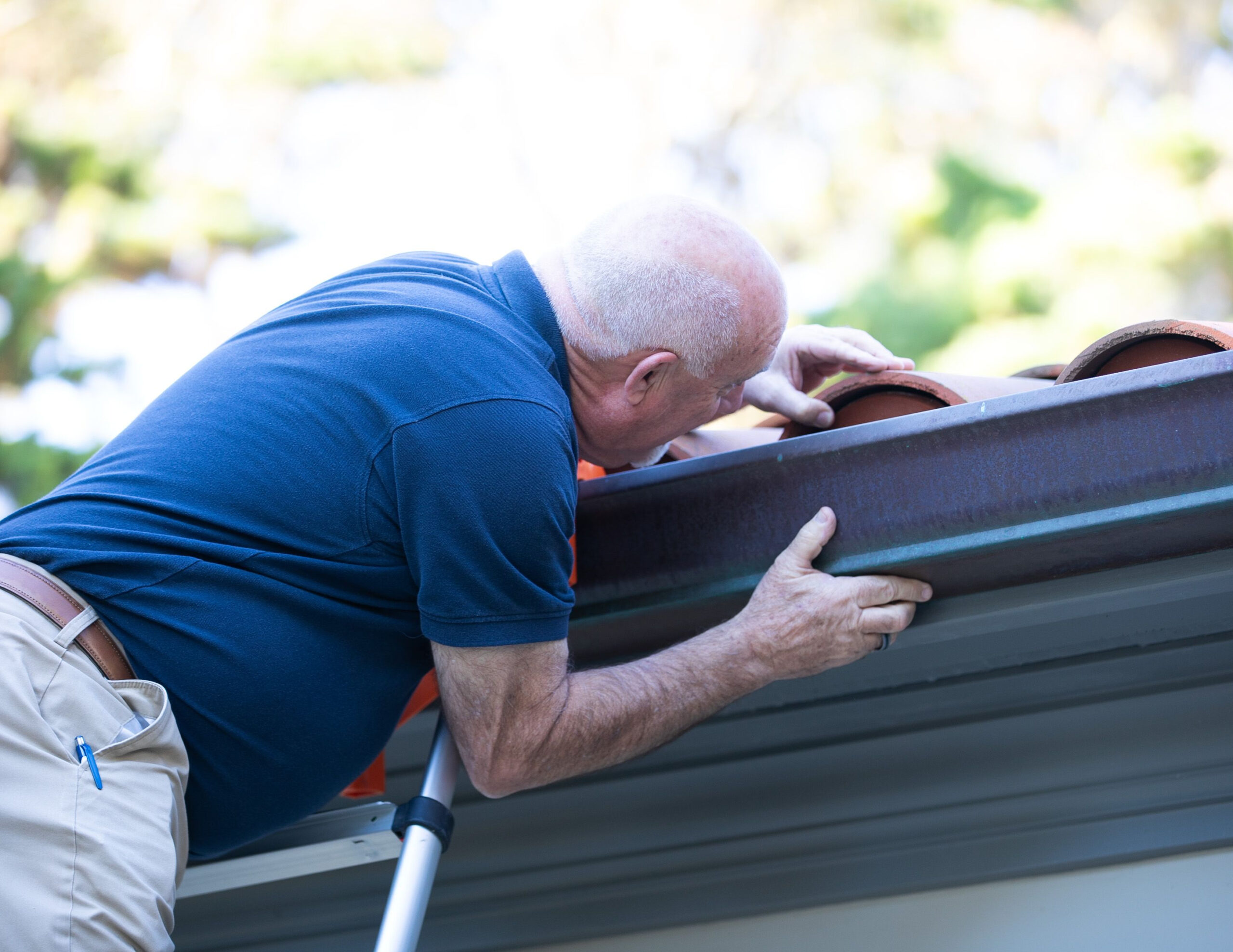 Technician performing roof inspection on building rooftop